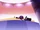 S2E22 Spider With a Top Hat falling over on stage.png
