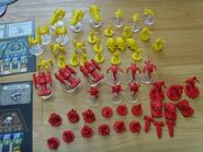 Terran and protoss pieces assembled. Terrans are colored red, and protoss are yellow.