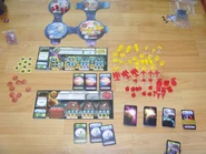 Complete setting of the game, minus the game board. The player sheets are laid together here.