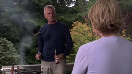 O'Neill holding a Fat Tire beer in one hand and burnt steak previously extinguished by beer in other