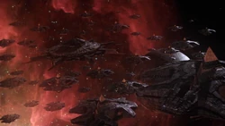 A fleet of Goa'uld ships in orbit of a planet