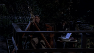 Jack O'Neill using a telescope to observe space.[1]