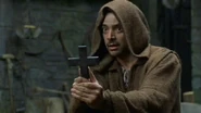 Simon holding a cross.