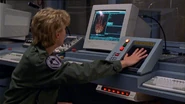 Sam using the palm scanner in 1999 during the Season 2 episode, "Show and Tell".