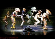 The racers jump to avoid Poppa, who's fallen on the tracks