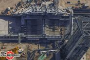 As of 18 April 2025, the flame bucket is installed in the flame trench, with water deluge plumbing nearing completion. c RGV Aerial Photography