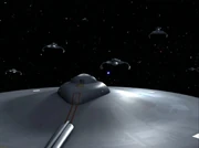 The USS Enterprise faces Klingon battlecruisers.