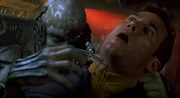 A drone uses assimilation tubules on an crewman from the USS Enterprise-E (2373).