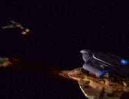 The USS Defiant protecting the CDS Prakesh from Klingon attack.