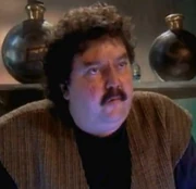 Meska () in his bar.