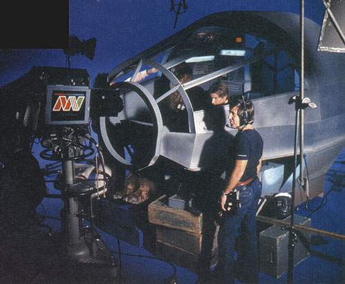 Harrison Ford and Peter Mayhew in the cockpit of the Millennium Falcon, as the producers stand by