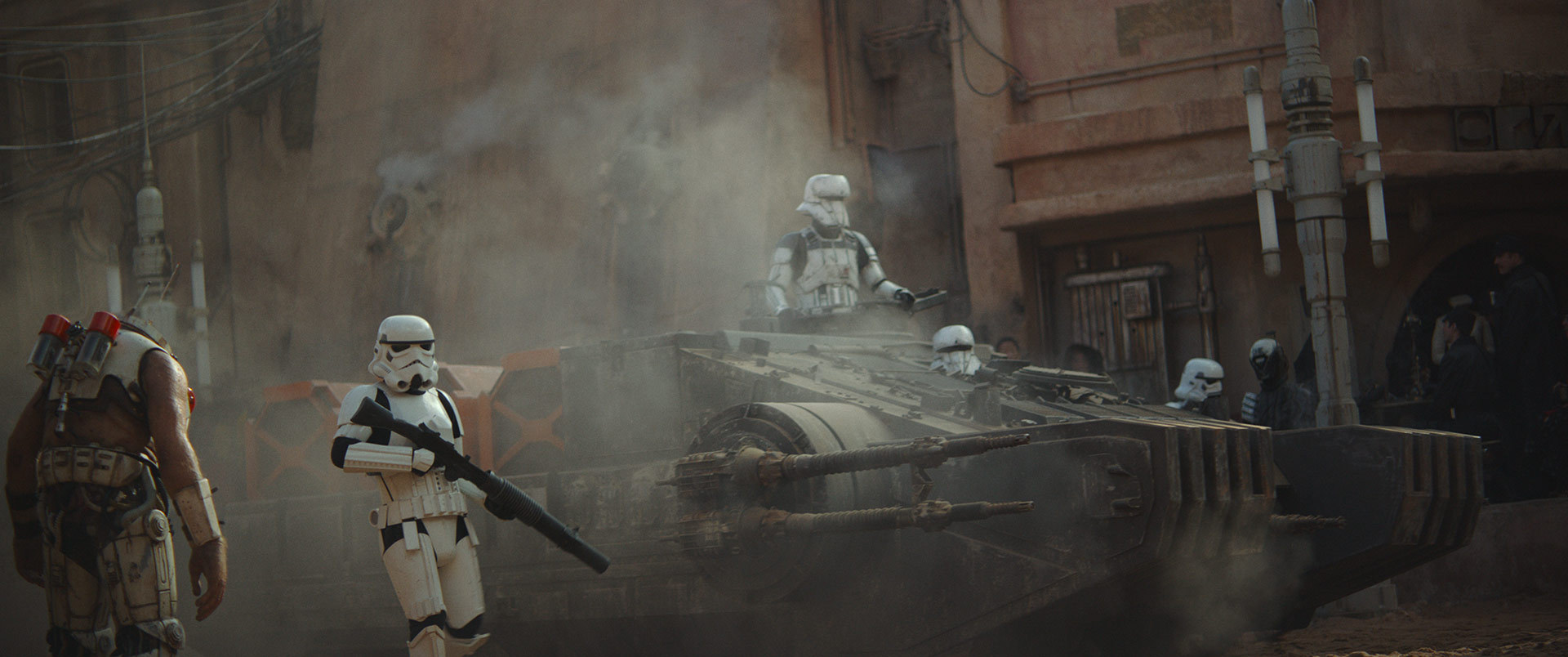 The Imperial tank proceeds through the enclosed Jedha streets