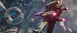 A T-65 X-wing piloted by  attacks the Scarif Shield Gate.