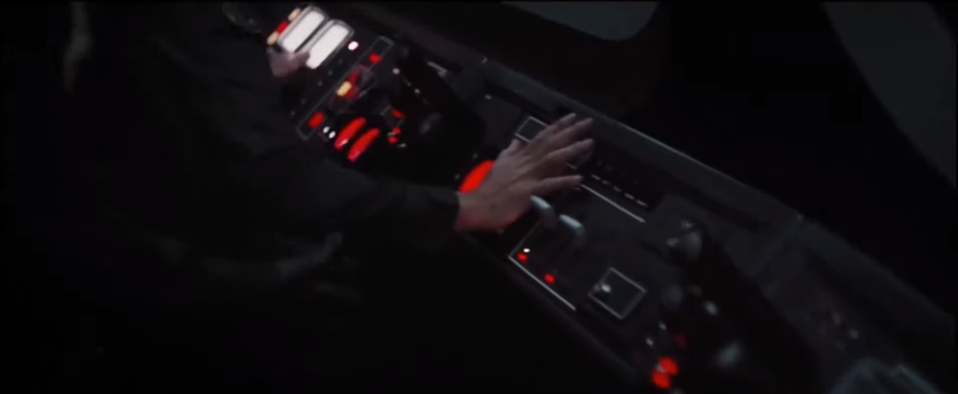 A gate officer pressing a button to close the Scarif shield gate.