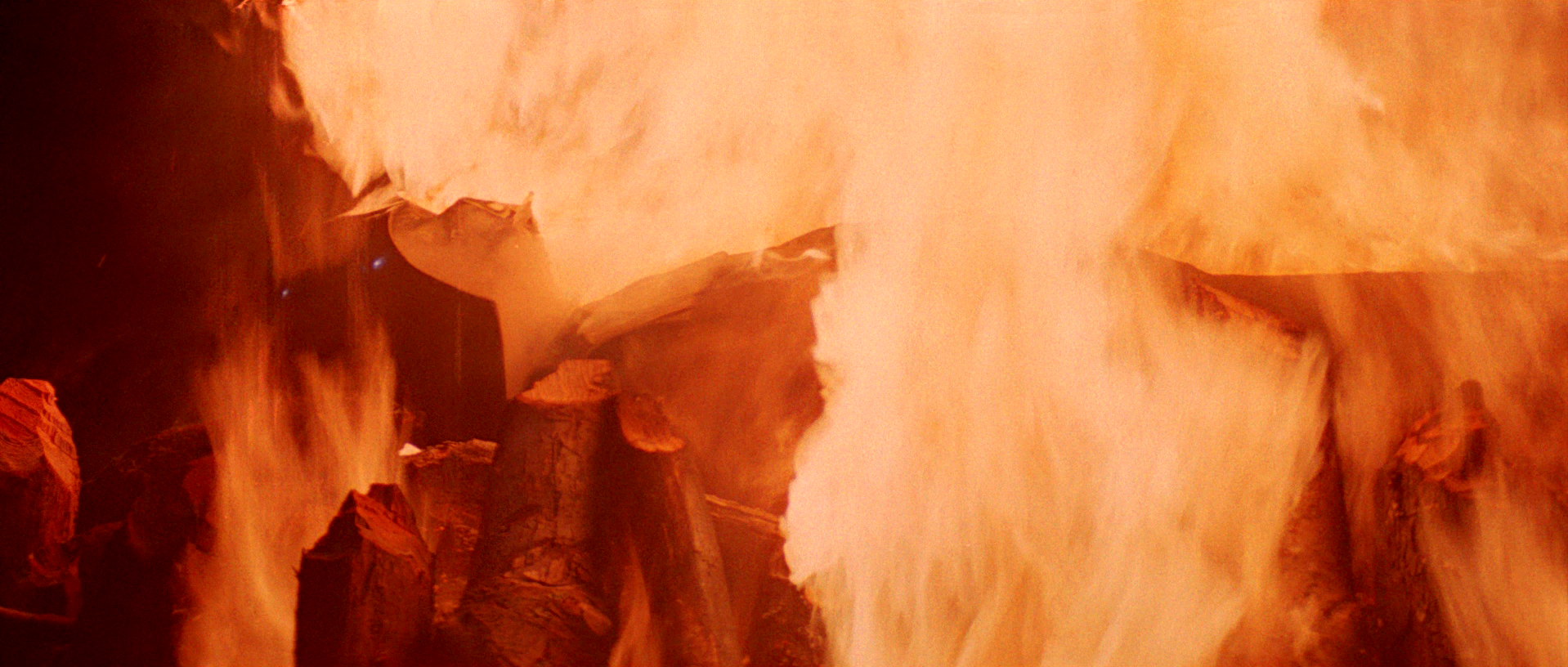 Darth Vader's armor burns on the funeral pyre.