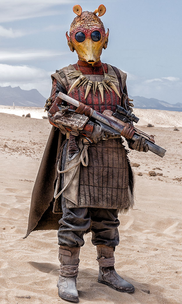 Chussido wore a necklace of fang-like objects and carried a blaster rifle.