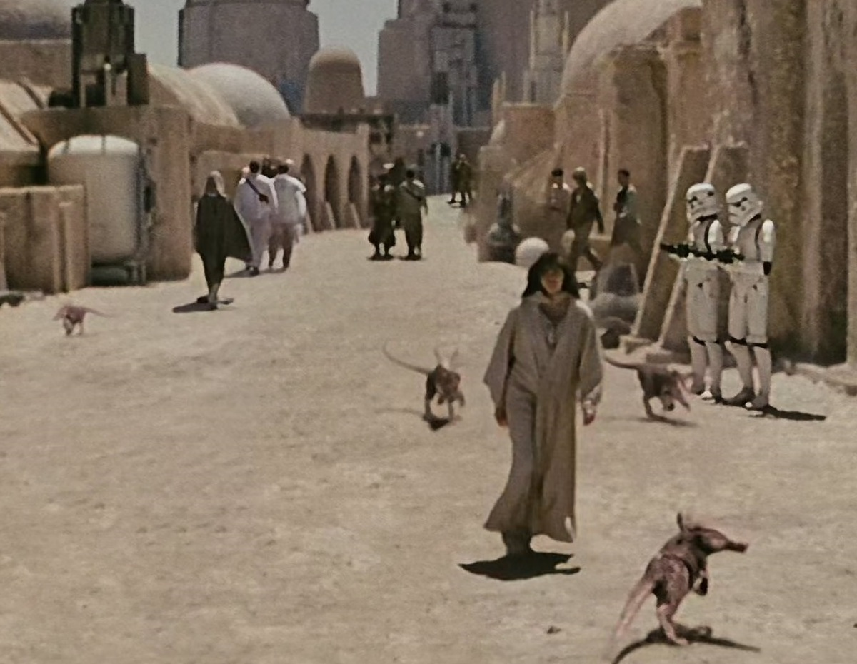 Four scurriers loitering in the streets of Mos Eisley