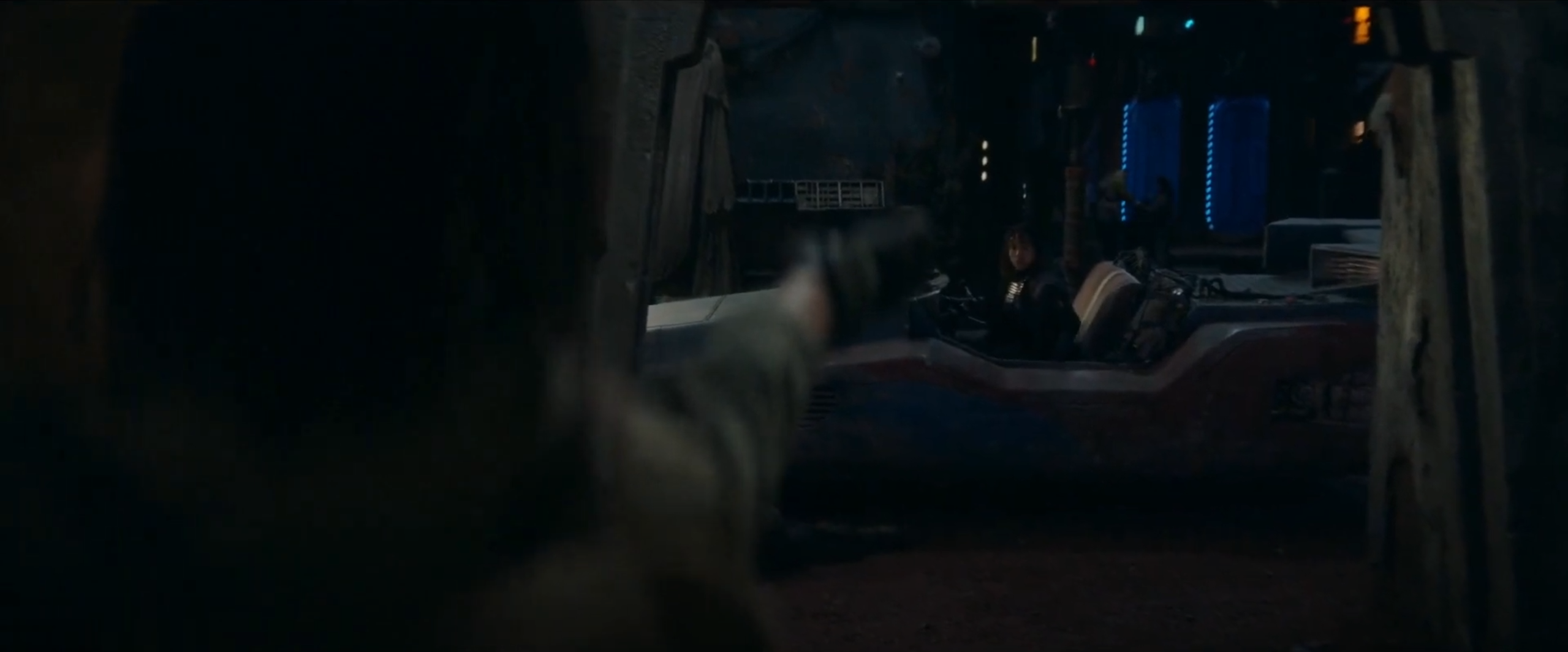 Osha (left) aims at her sister Mae (right) while she tries to escape in a speeder.