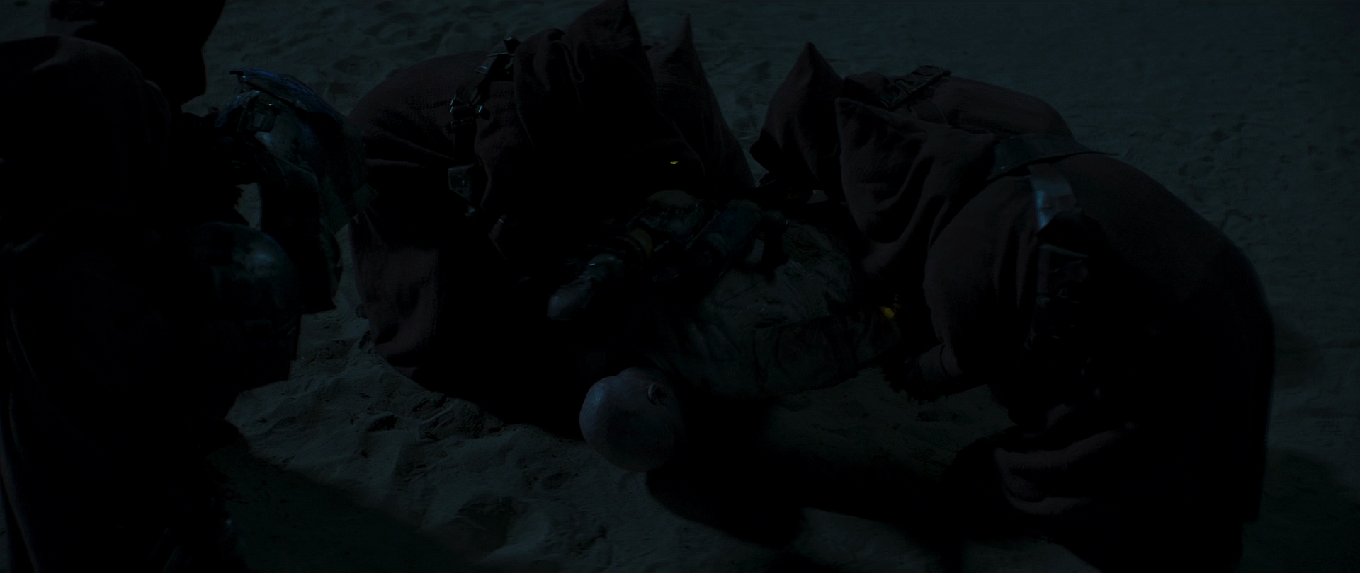 Jawas steal Boba Fett's armor, as he is lying on the desert ground