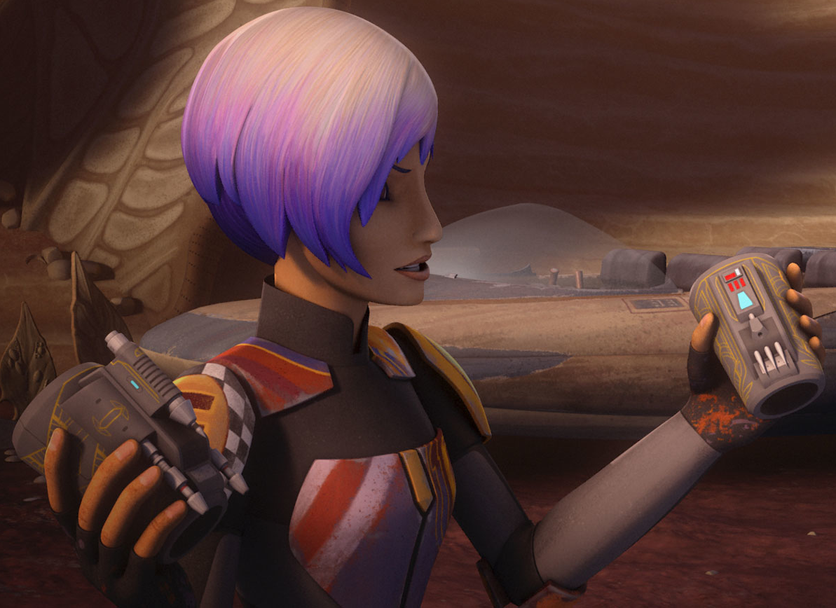 Sabine Wren holds up Mandalorian vambraces