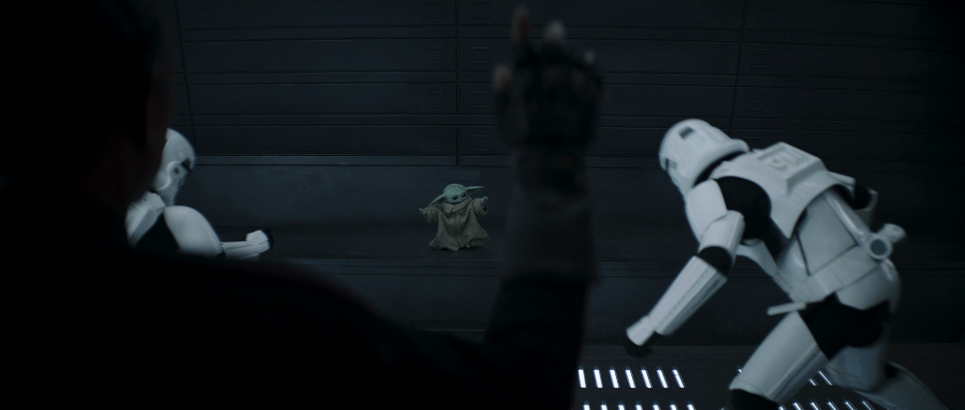 Gideon watches as Grogu thrashes two stormtroopers.