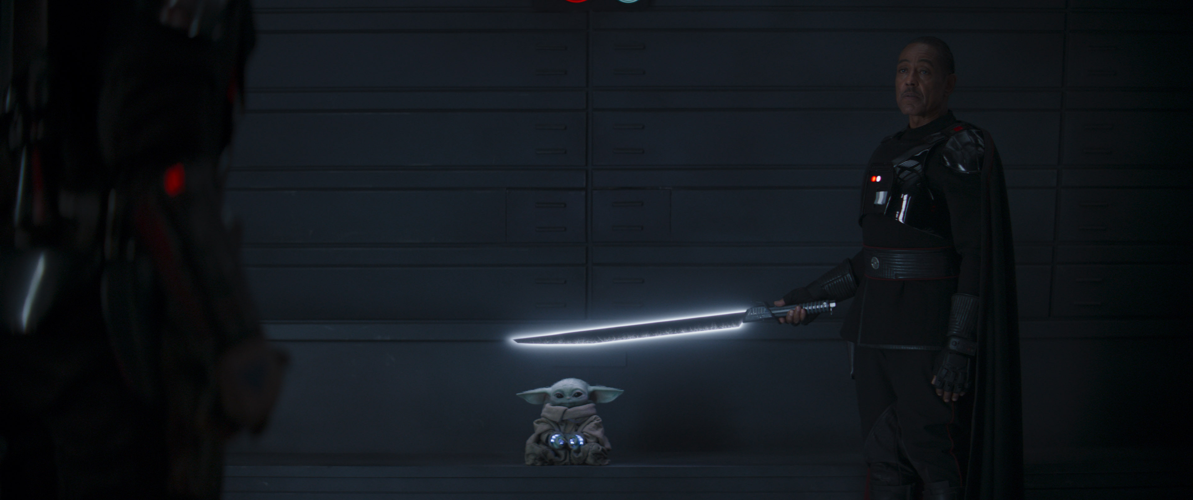 Moff Gideon holds Grogu hostage with the Darksaber.