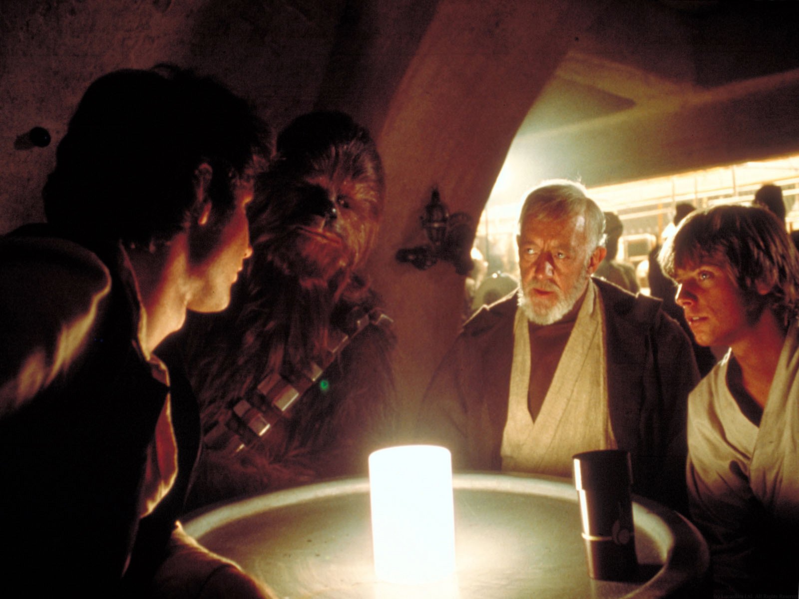 Solo and Chewbacca negotiate passage fees with Kenobi and Skywalker in Chalmun's Cantina.