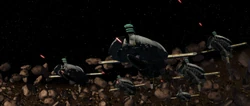 The Munificent-class frigates emerge from the asteroids.