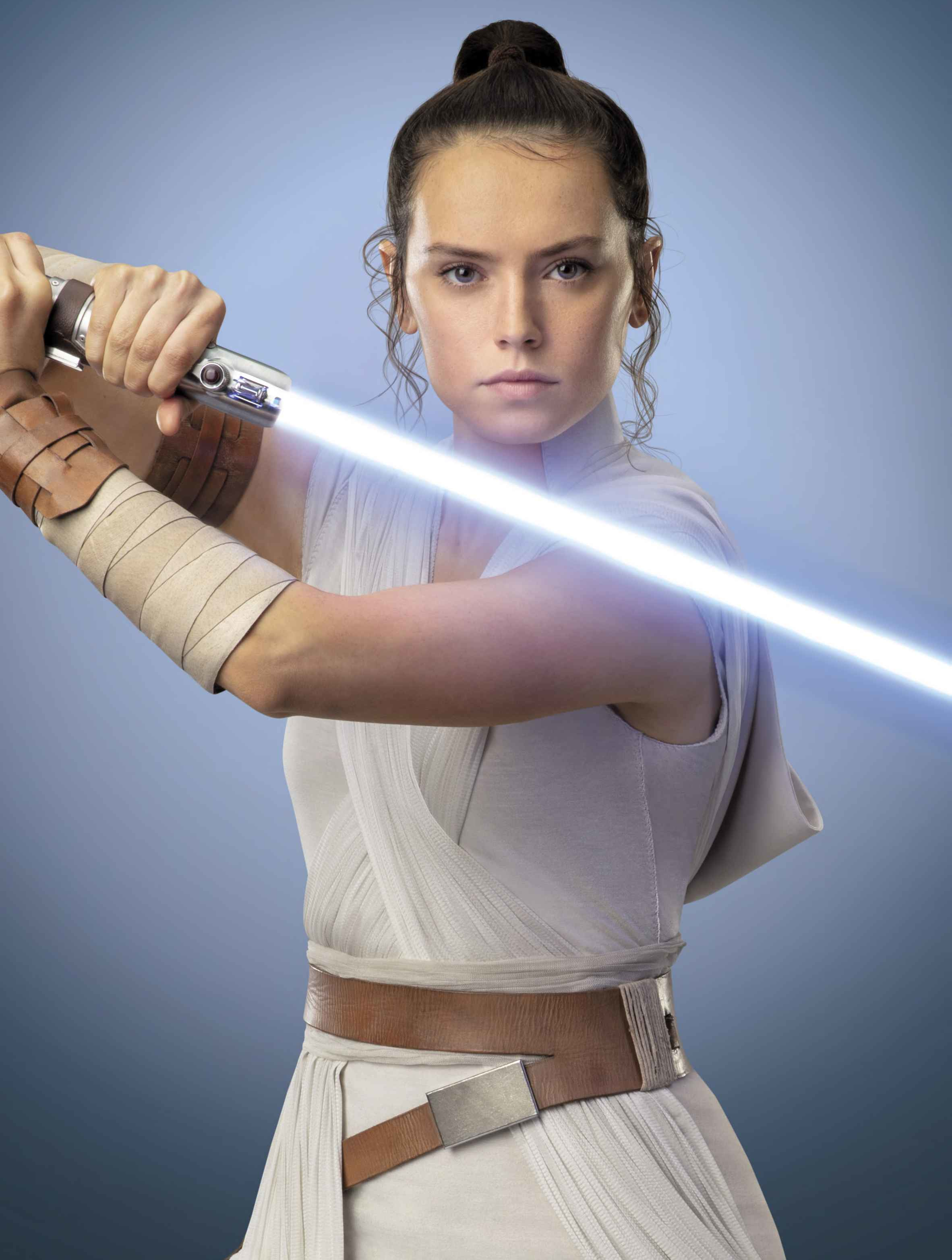 Rey wields the lightsaber of Anakin and Luke Skywalker as her own.