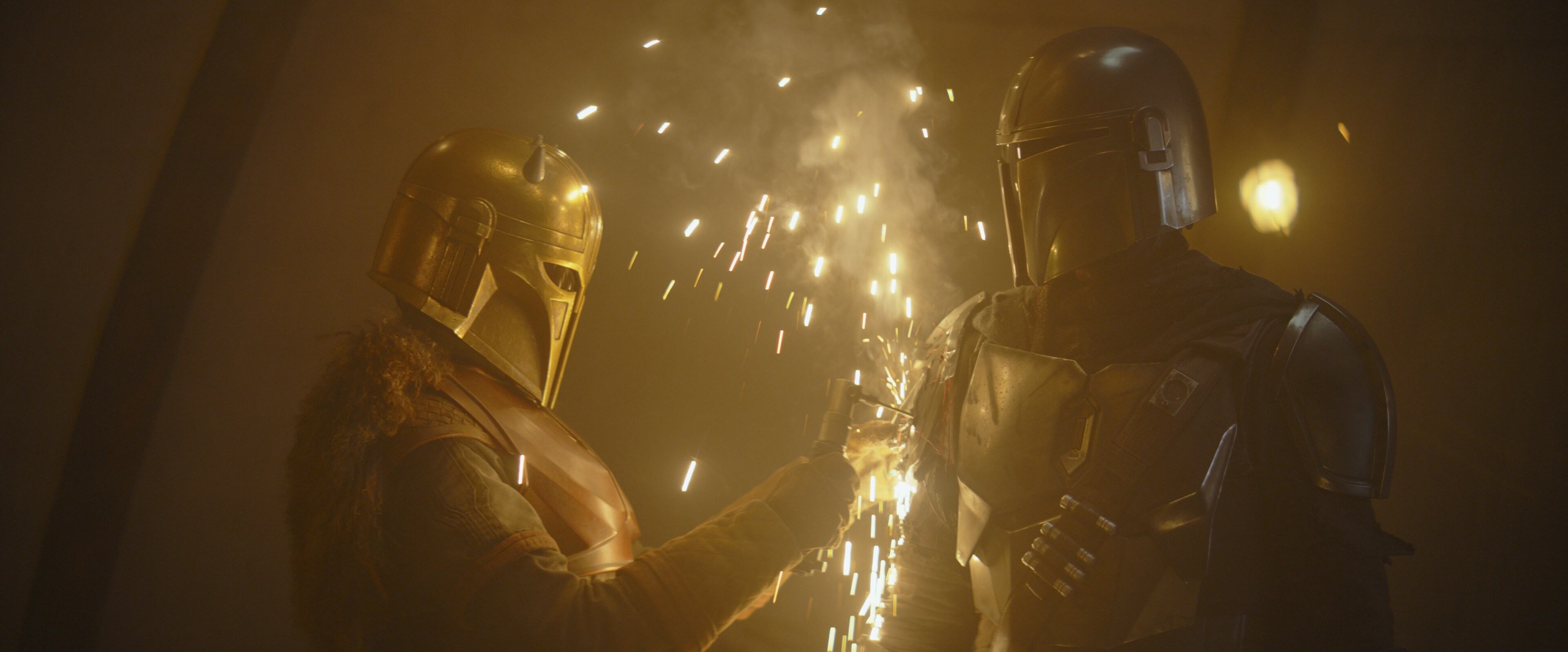 The Armorer welds the signet of Clan Mudhorn onto his pauldron.