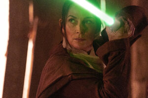 Indara ignites her lightsaber.