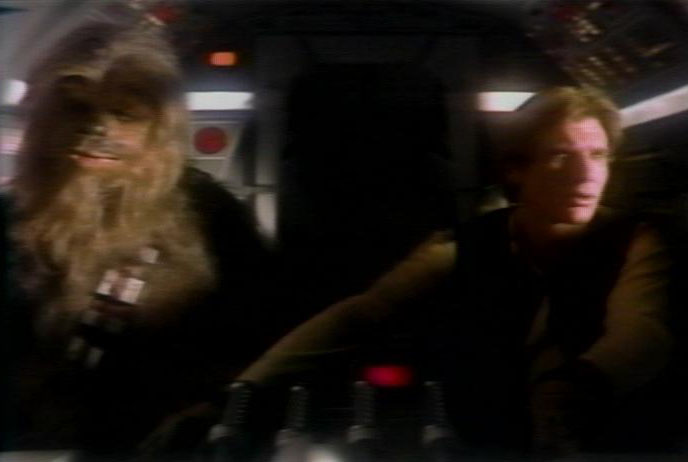 Chewbacca and Han Solo in the Millennium Falcon, on the run from the Empire.