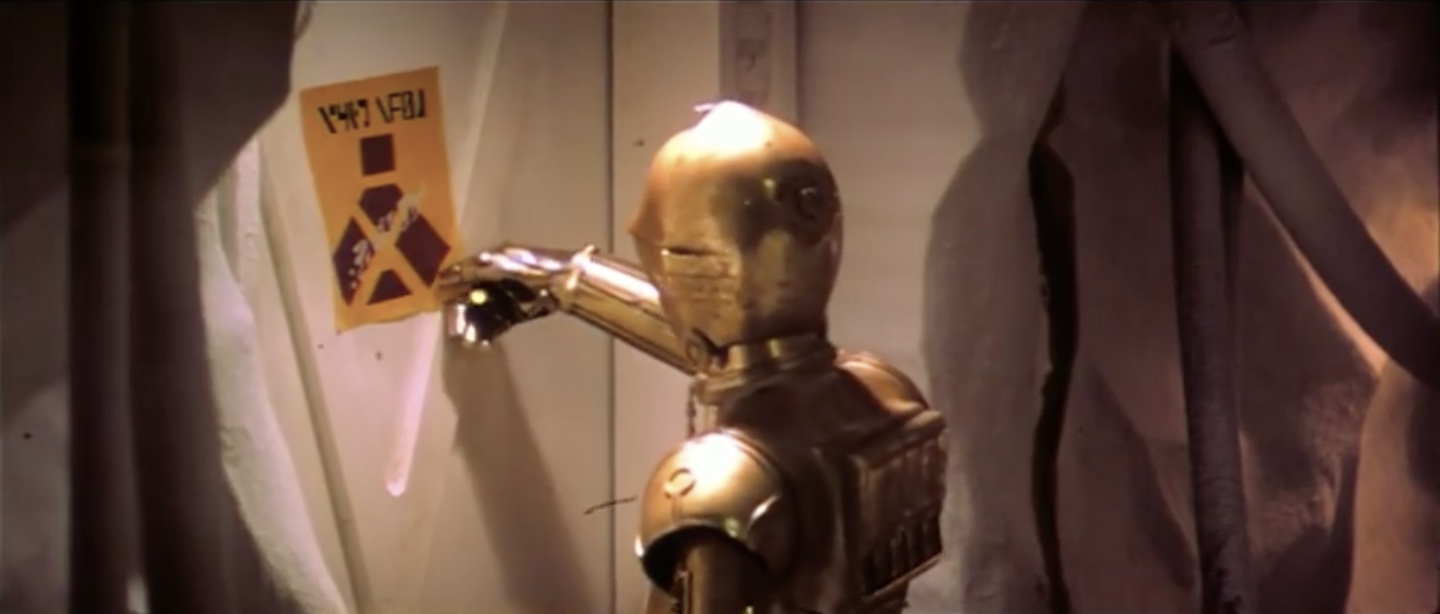 Threepio rips a warning sign from an Echo Base door in a deleted scene from The Empire Strikes Back.