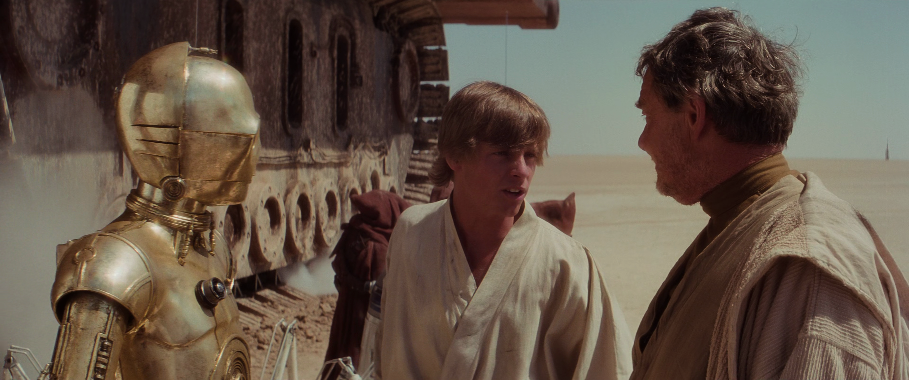 Lars and Skywalker purchase C-3PO from Jawas.