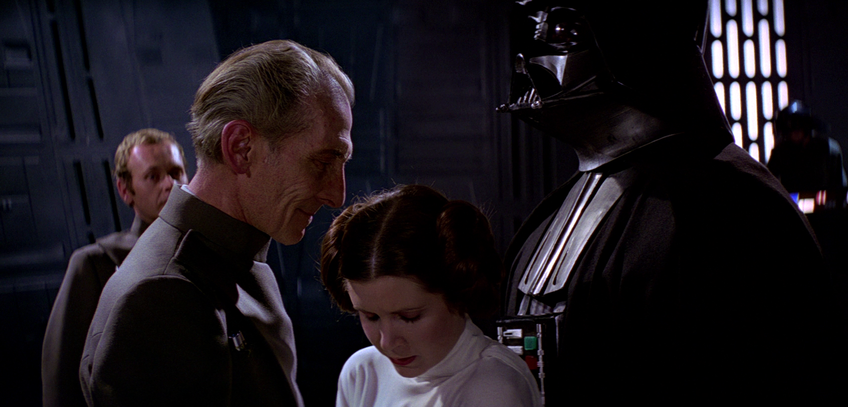 Grand Moff Tarkin and Darth Vader force a captive Leia to watch as they destroy Alderaan, killing her parents.