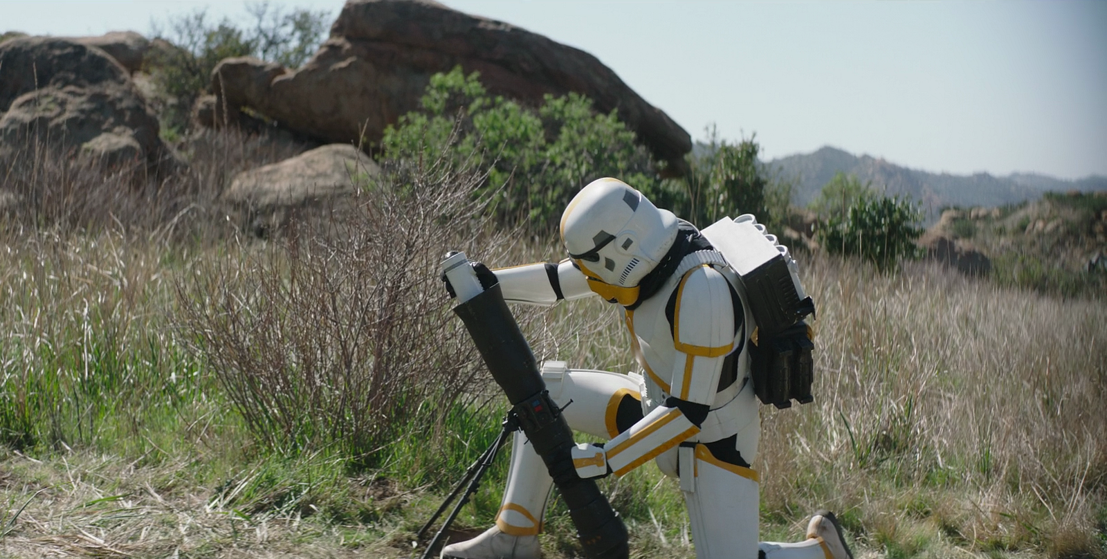 An artillery stormtrooper loads a mortar shell into the launch tube.