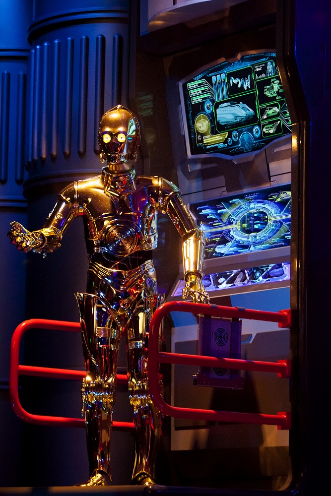 C-3PO makes last-minute repairs to a Star Tours StarSpeeder 1000.