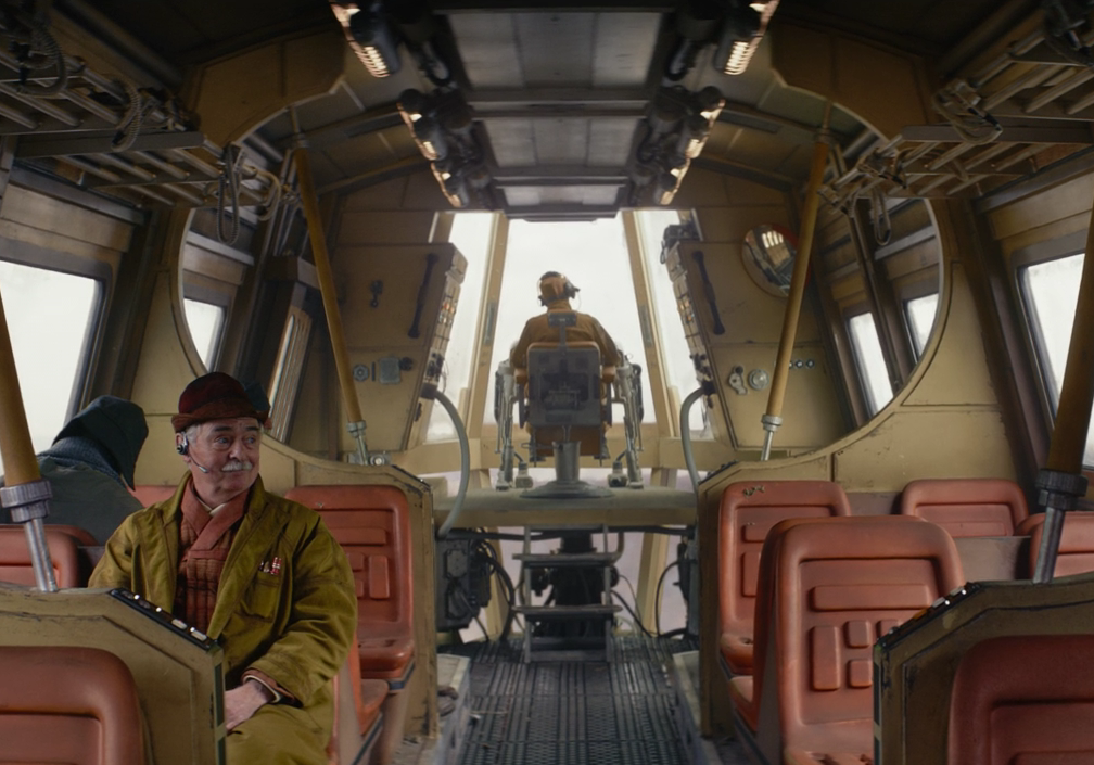 The pilot of a shuttle ferry was seated in an elevated cockpit.