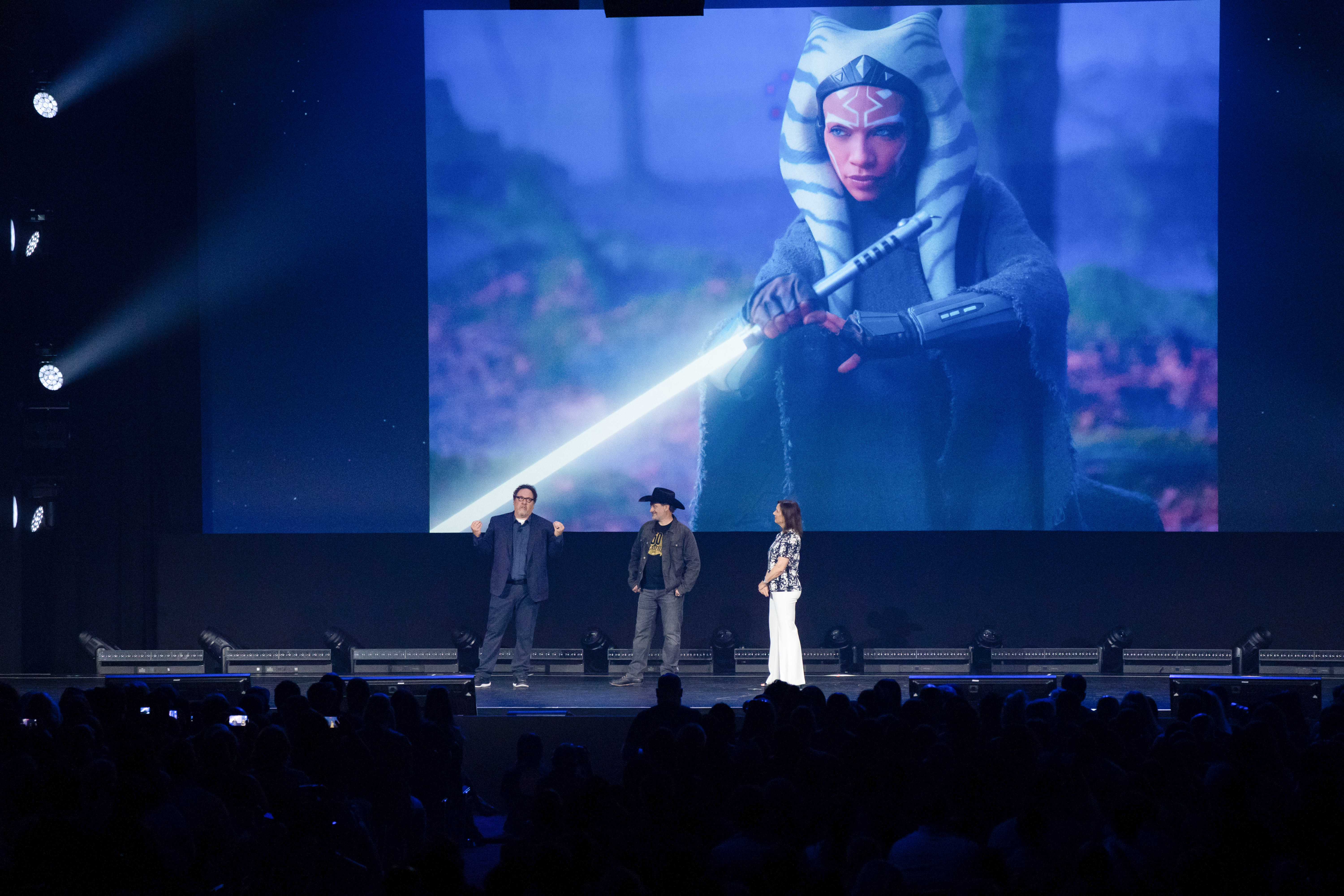 Jon Favreau, Dave Filoni, and Kathleen Kennedy presenting a production still from Ahsoka at D23 Expo 2022