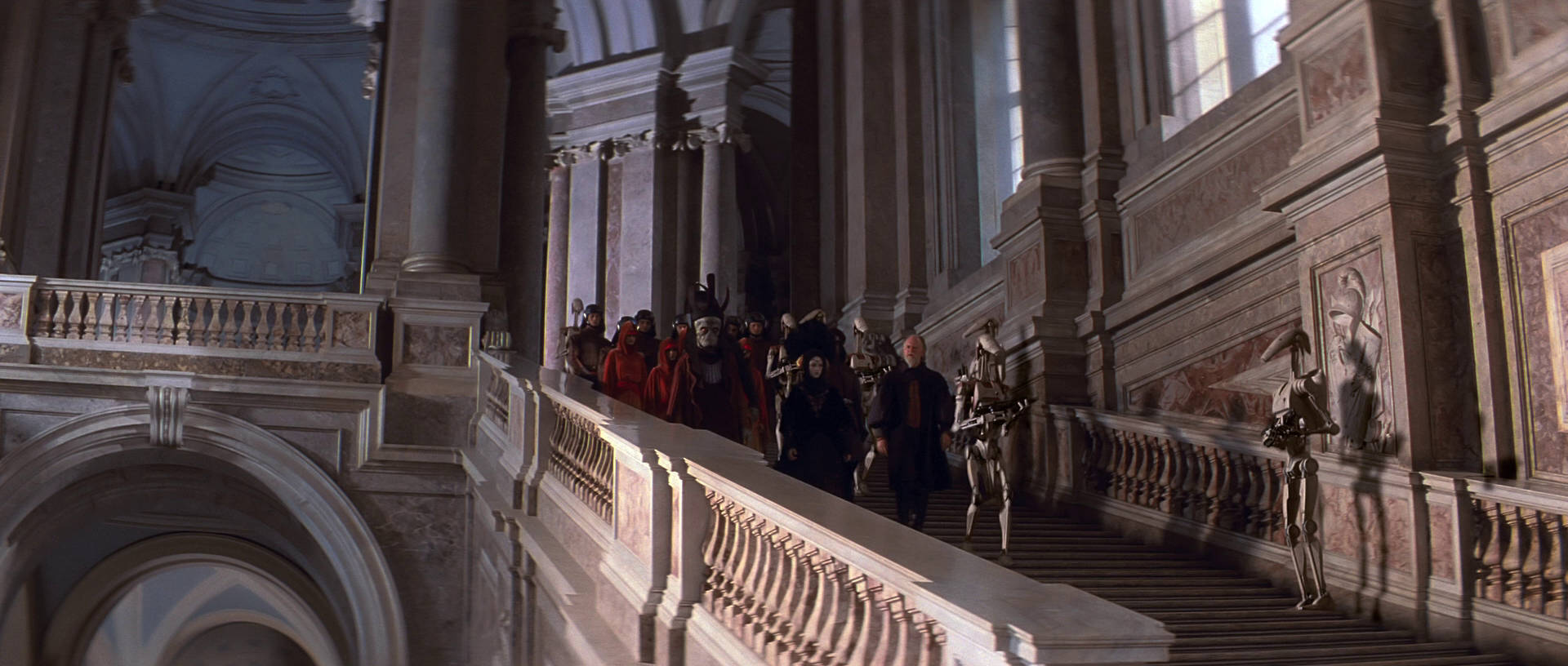 Nute Gunray descends the stairs of Theed Royal Palace with the captive Queen Amidala.