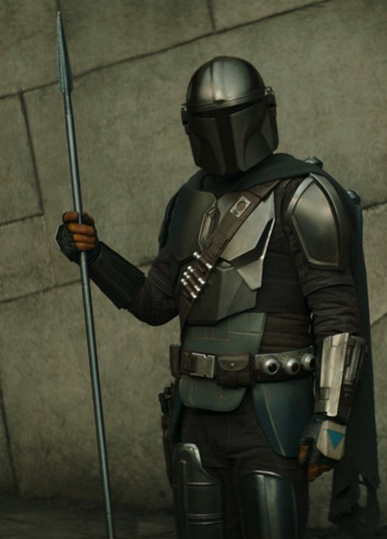 Din Djarin in his full beskar armor while carrying the beskar spear he was gifted by Ahsoka Tano.