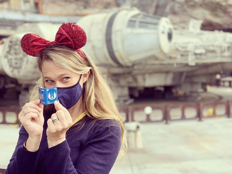 S.T. Bende at Star Wars: Galaxy's Edge with a copy of Star Wars: The Tiny Book of Jedi