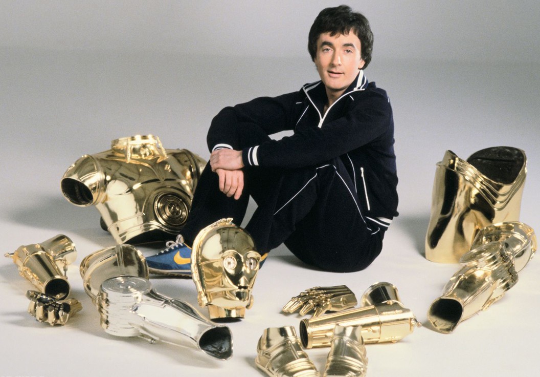 Daniels posing with the pieces of his C-3PO costume from the Original Trilogy.