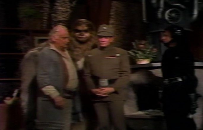 Imperial officers questioning Chewbacca's family and Saun Dann