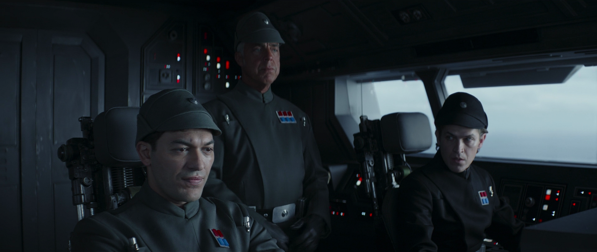 The Imperial captain and his bridge officers in the Imperial Gozanti-class Assault Carrier's cockpit.