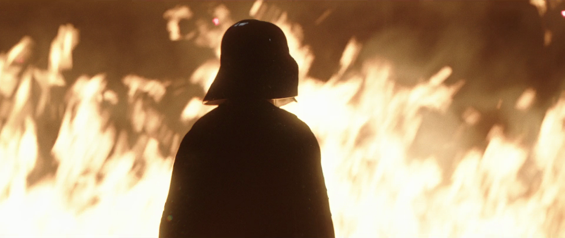 Darth Vader stands before the fire as he allows Obi-Wan Kenobi to escape.