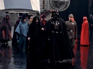 Palpatine, Vader, Jerjerrod, and his advisors walking through the Death Star's hangar
