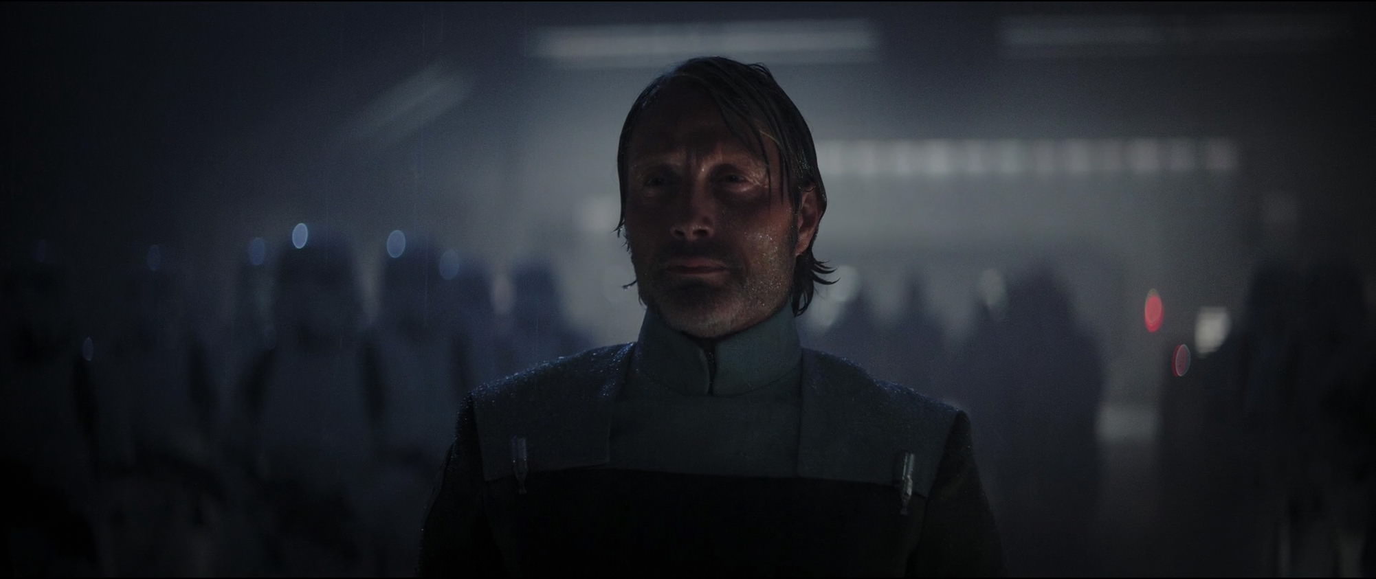 Galen Erso in an Imperial uniform surrounded by Imperial stormtroopers.