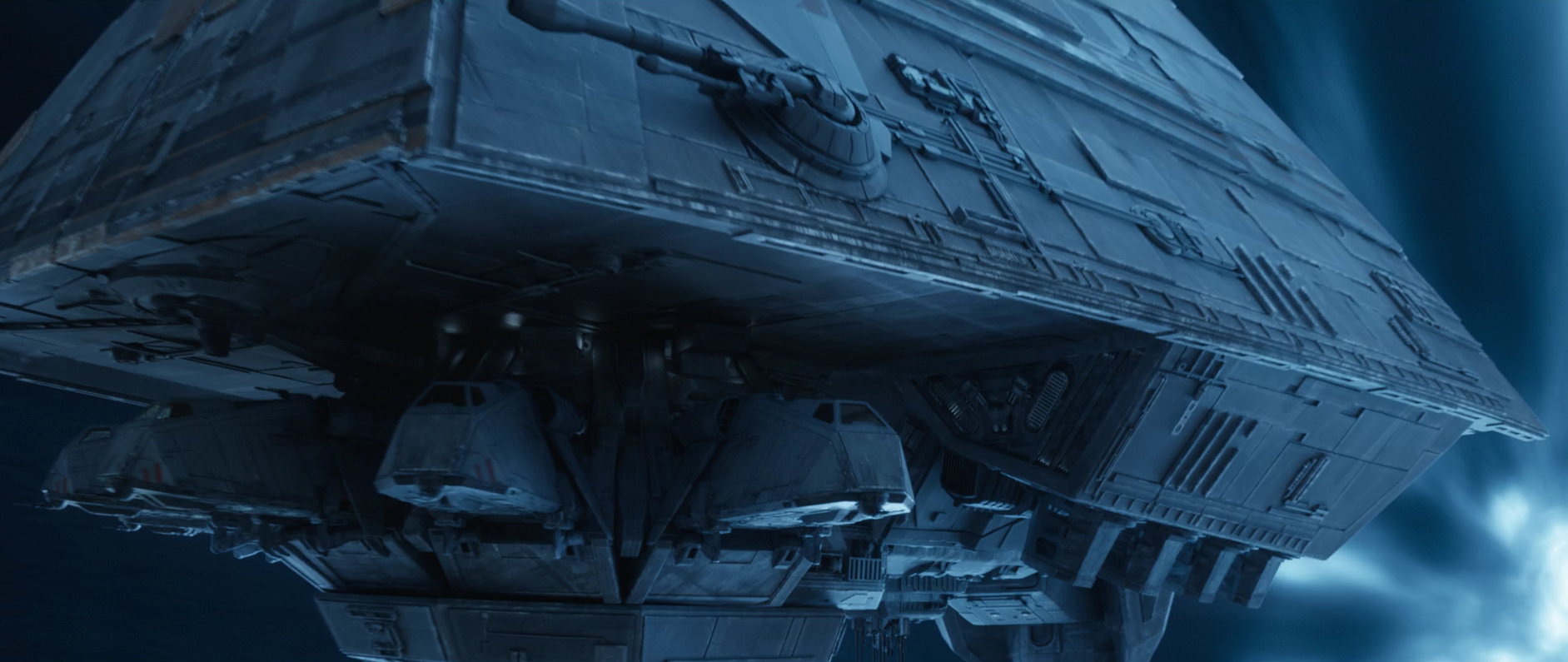 The docking bay of a personnel carrier with Tac-Pods docked in their stations. Note the heavy laser cannons above