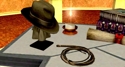 A whip on display, accompanied by an equally mysterious fedora.